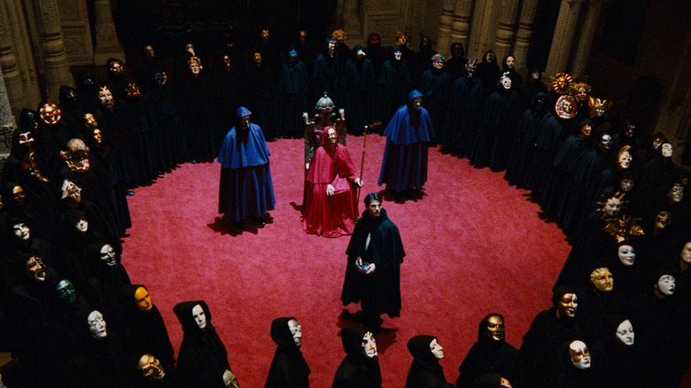 Dr. Bill Harford surrounded by creepy costumed weirdos at the orgy in Eyes Wide Shut