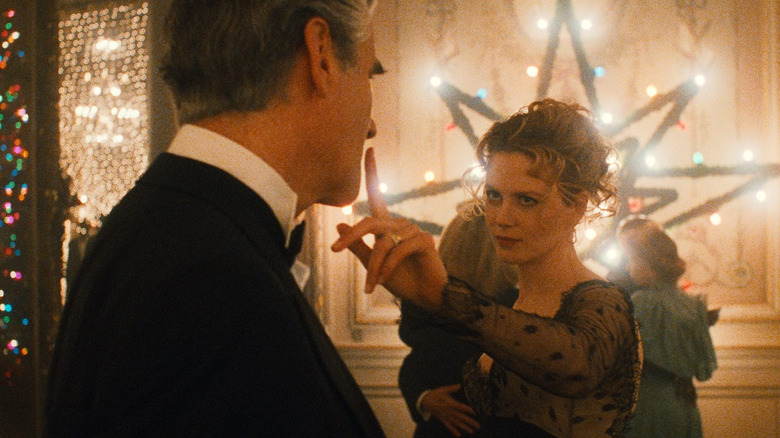 Alice Harford holds a finger up to a man's face in Eyes Wide Shut