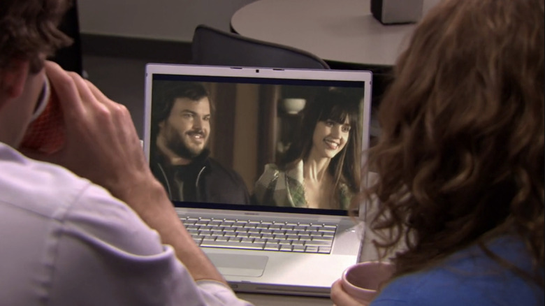 Jim (John Krasinski) and Pam (Jenna Fischer) watch Jack Black and Jessica Alba in the fake movie Mrs. Albert Hannaday in The Office
