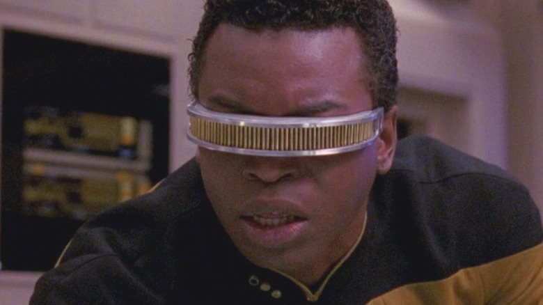 Geordi La Forge analyzes read-outs in his high-tech visor