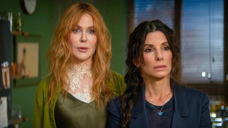 Nicole Kidman as Gillian Owens standing next to Sandra Bullock as Sally Owens in their kitchen in Practical Magic 2