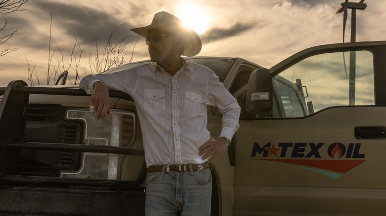 Tommy Norris wearing standing in front of a truck on Landman