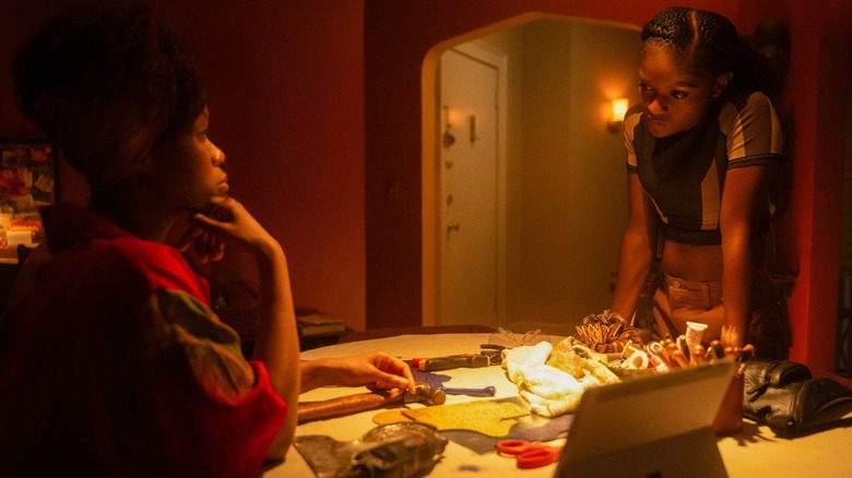 Riri talking to her mother from across a table