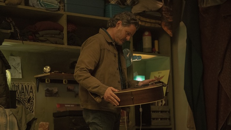 Joel looking at Ellie's guitar in The Last of Us season 2