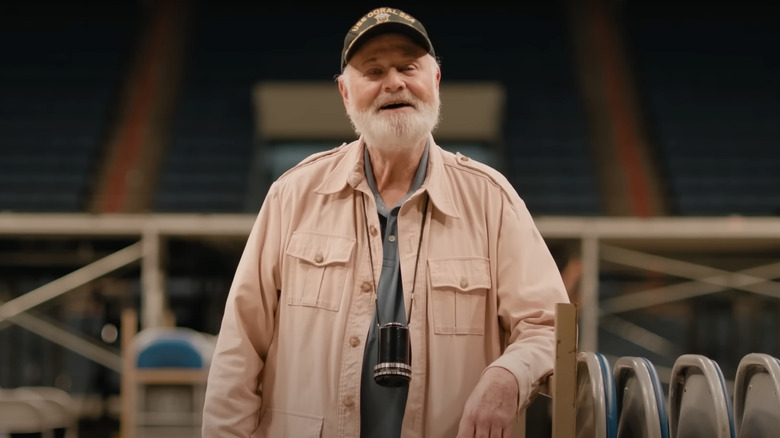 Rob Reiner as Marty DiBergi in an empty arena in Spinal Tap 2