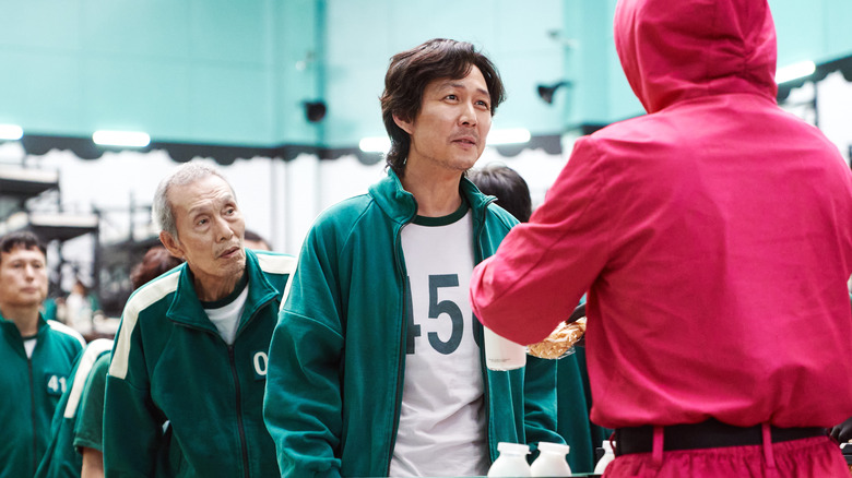 Squid Game Season 1 Gi-hun and Il-Nam Lee Jung-jae Oh Young-soo in line during games