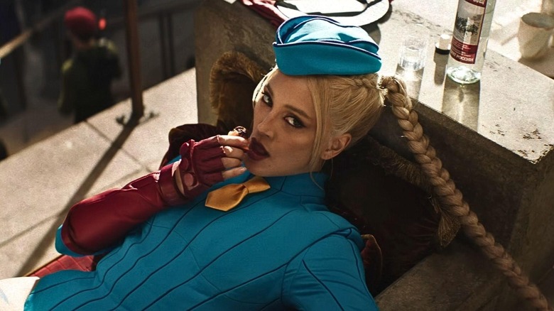 Mel Jarnson as Cammy laying down and eating fruit in Street Fighter (2026)
