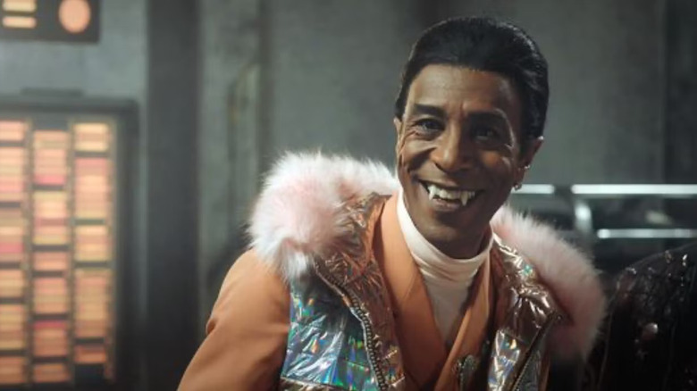 The Cat, smiling and wearing a shiny vest with fur trim in an episode of Red Dwarf