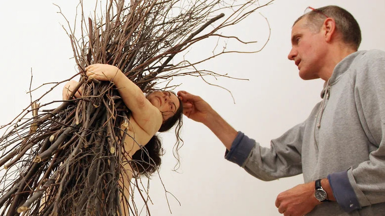 Sculptor Rin Mueck working on one of his installations.