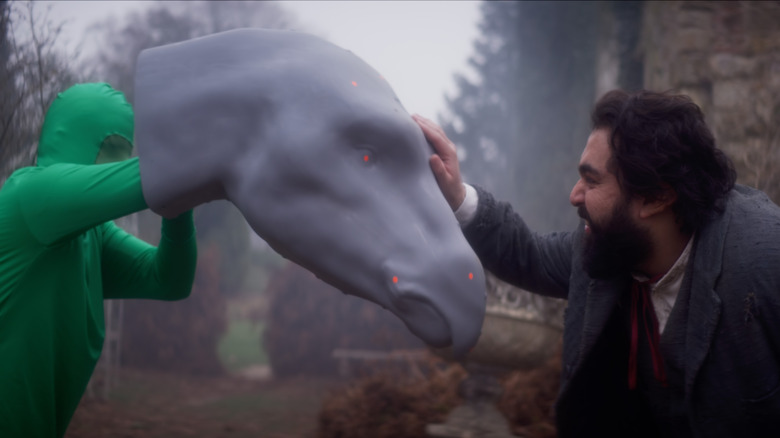 Abel interacting with puppeteer holding Gregory head.