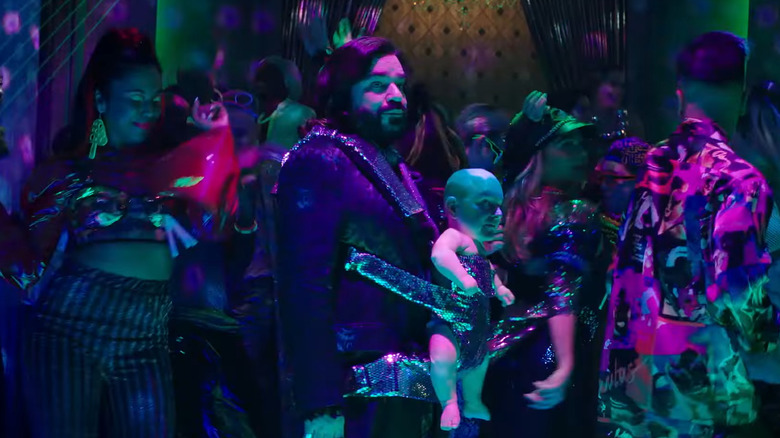 Matt Berry and Mark Proksch walking around a party in What We Do in the Shadows