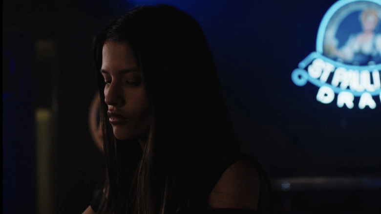 Avery sits at the bar in a strip club looking forlorn