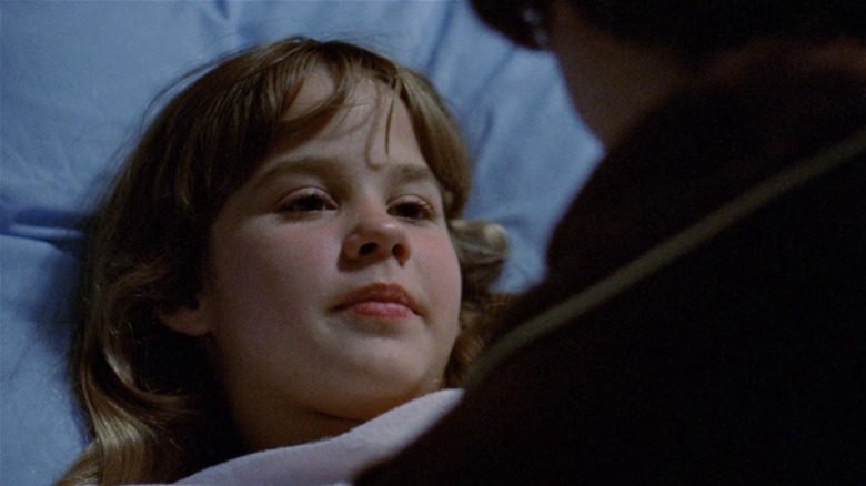 Linda Blair laying in bed in The Exorcist