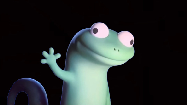 Tom the lizard raises his green hand up with his eyes mindlessly pointed in opposite directions in "Hoppers"