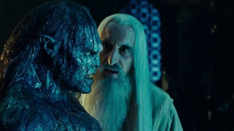 Saruman inspects Lurtz the Uruk-hai, looking at the side of his face