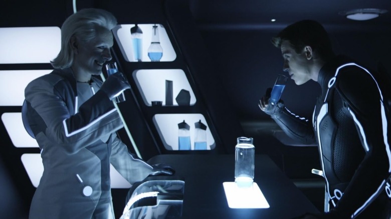 Michael Sheen as Castor drinking with Garrett Hedlund's Sam Flynn in Tron: Legacy