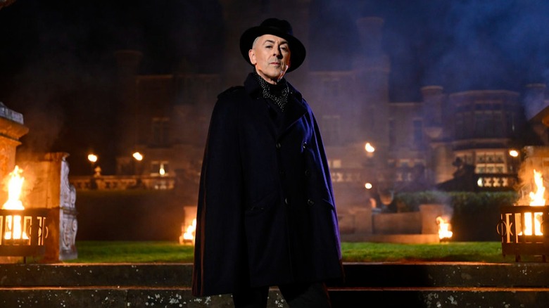 Alan Cumming in front of Ardross Castle on The Traitors US
