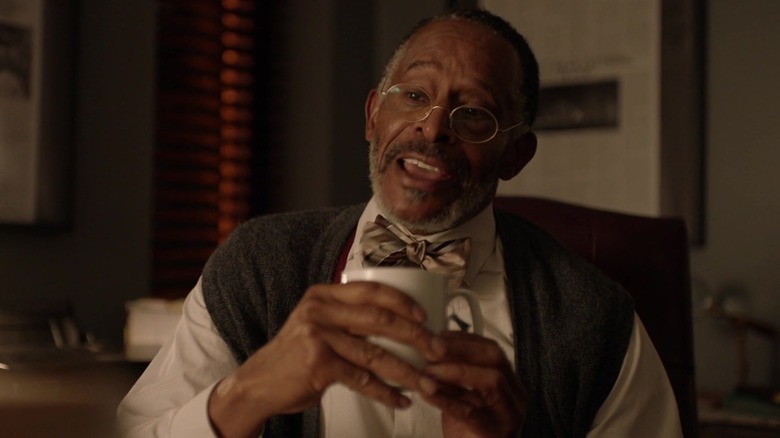 Antonio Fargas as David Poe, holding a coffee mug on Black Lightning