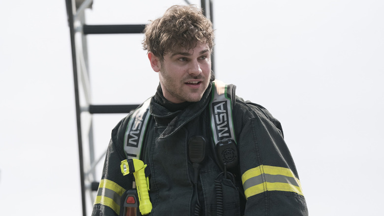 Grey Damon as Jack Gibson standing near a ladder in Station 19