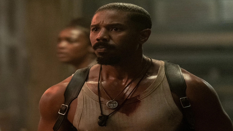 Michael B. Jordan as Smoke, looking scared in a barn in Sinners