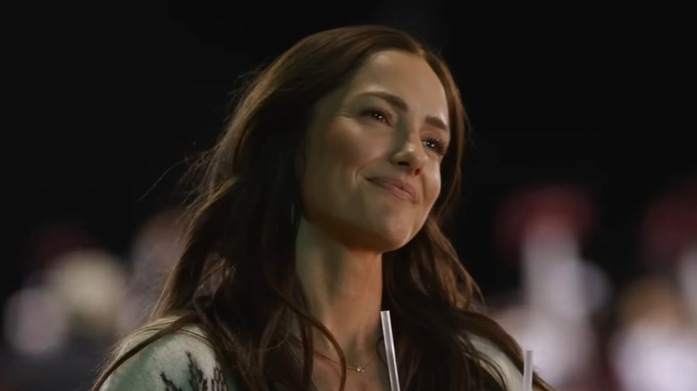 Minka Kelly as Quinn O'Grady, smiling with a drink on Ransom Canyon