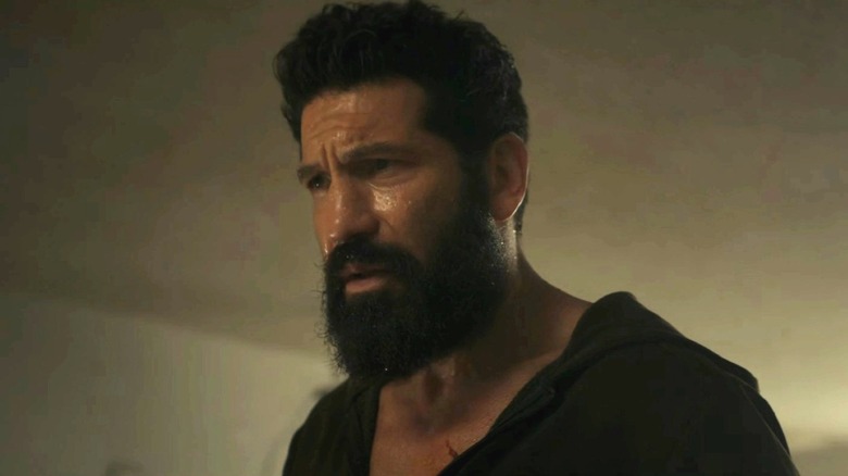 Jon Bernthal as Frank Castle covered in sweat and looking off to the side in an empty room in The Punisher: One Last Kill