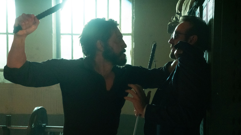 Jon Bernthal as Frank Castle shoving Charlie Cox as Matt Murdock against a wall with a weapon raised in his other hand in Daredevil: Born Again