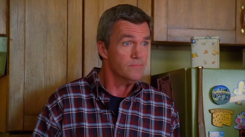 Neil Flynn as Mike Heck, looking bewildered in his kitchen on The Middle