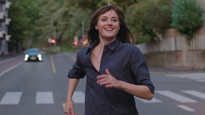woman running in the street smiling