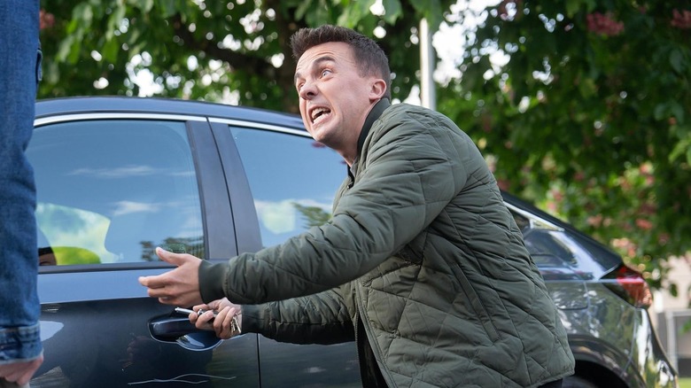 Frankie Muniz as Malcolm pointing at his car in exasperation in Malcolm in the Middle: Life's Still Unfair