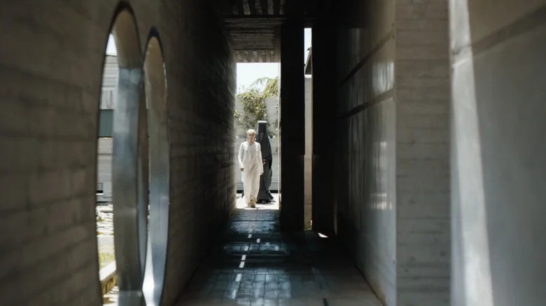 Florence Pugh's Princess Irulan is seen at the end of a corridor in Dune Part Two