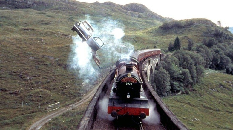 The Weasley family's flying car next to the Hogwarts Express in Harry Potter and the Chamber of Secrets