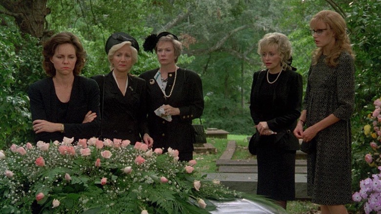 M'Lynn, Clairee, Ouiser, Truvy, and Annelle gather around Shelby's coffin in Steel Magnolias