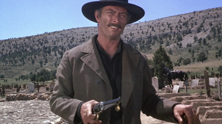 Angel Eyes holding fun in graveyard in The Good, the Bad, and the Ugly