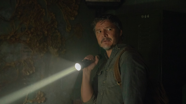 Joel Miller (Pedro Pascal) holding a flashlight in "The Last of Us"
