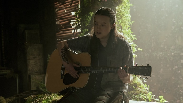 Ellie (Bella Ramsey) plays acoustic guitar in "The Last of Us"