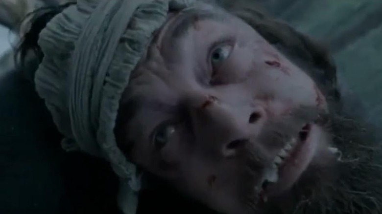 Hugh Glass wincing in pain in The Revenant.