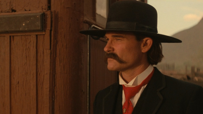 Kurt Russell as Wyatt Earp looking into the distance in Tombstone