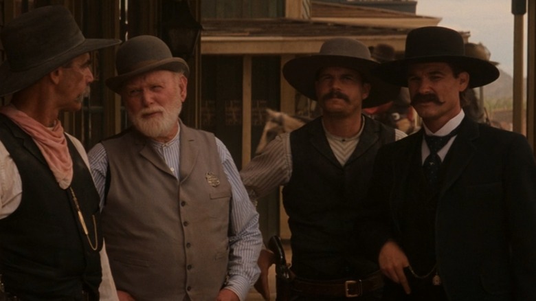 Sam Elliot as Virgil Earp, Harry Carey Jr. as Marshall White, Bill Paxton as Morgan Earp, and Kurt Russell as Wyatt Earp in Tombstone