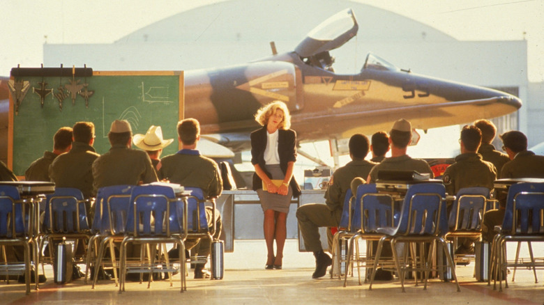 Kelly McGillis as Charlie Blackwood teaches a hangar full of flyboy students in Top Gun