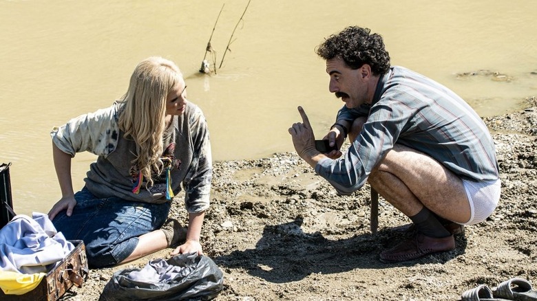 Borat scolding his daughter in the mud in Borat Subsequent Moviefilm