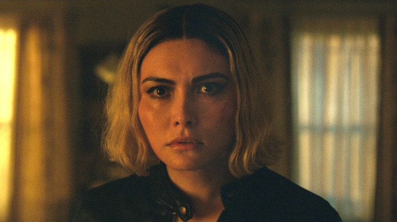 Daniella Pineda as Anaïs standing in the living room in The Accountant 2