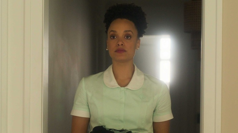 Britne Olford as Missy, walking down a lit hallway on Sirens