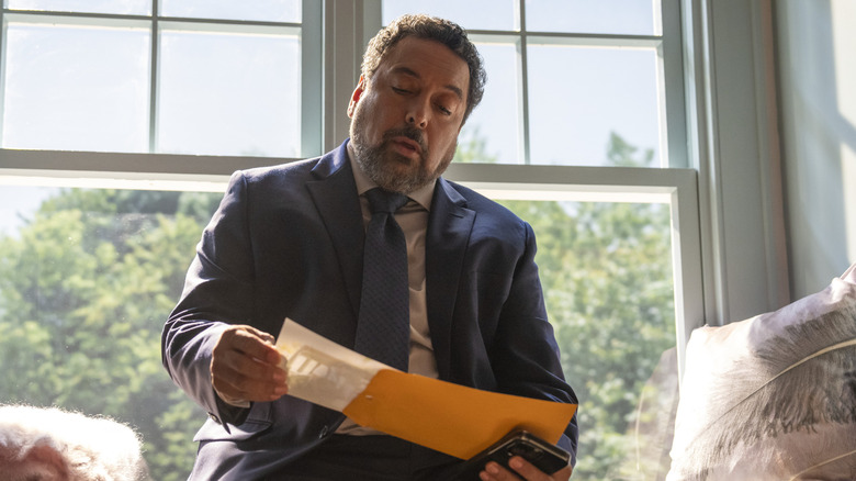 Felix Solis as Jose, examining a photo in an envelope on Sirens