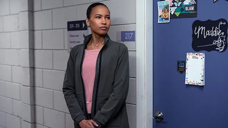 Fola Evans-Akingbola stands guard outside Maddie's bedroom as Chelsea Arrington in The Night Agent
