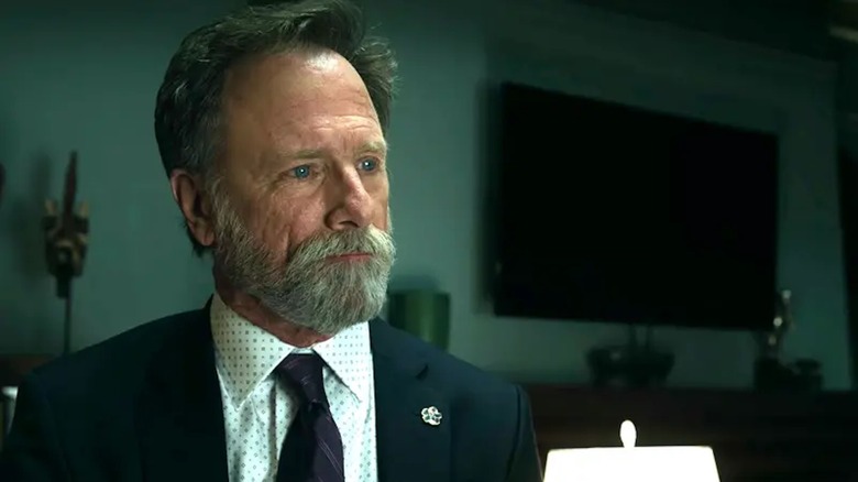 Louis Herthum schemes in front of an adorably tiny lamp as Jacob Monroe in The Night Agent