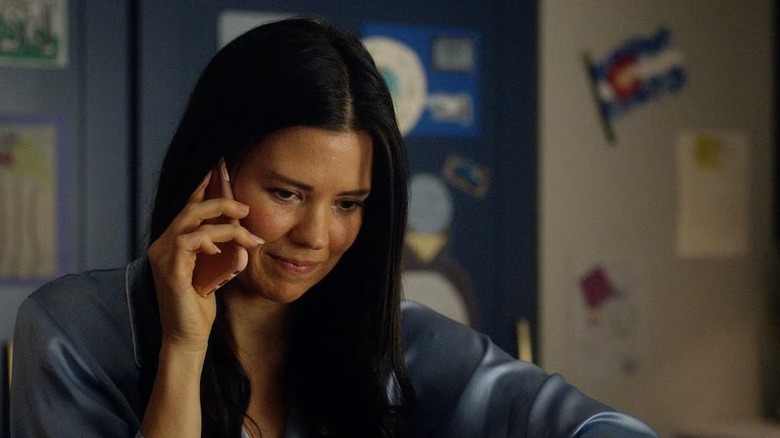 Kate speaks on her cell phone in Resident Alien