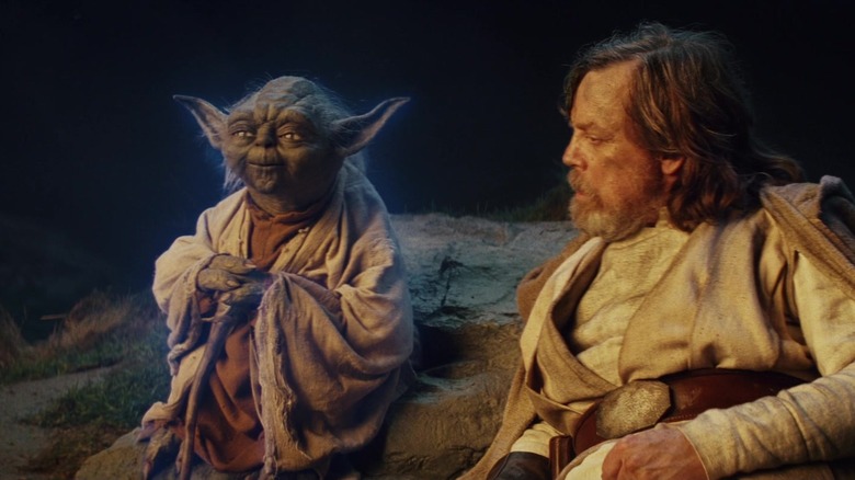 Yoda's Force ghost sitting next to Mark Hamill as Luke in Star Wars: The Last Jedi