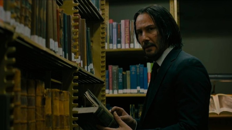 John Wick wielding a book
