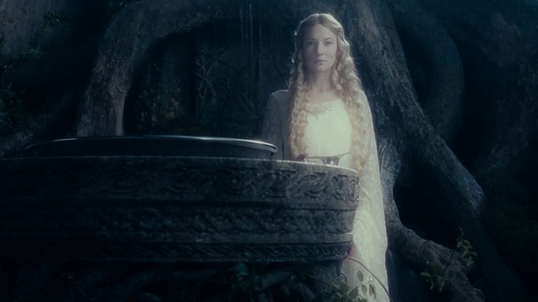 Galadriel stands next to her mirror